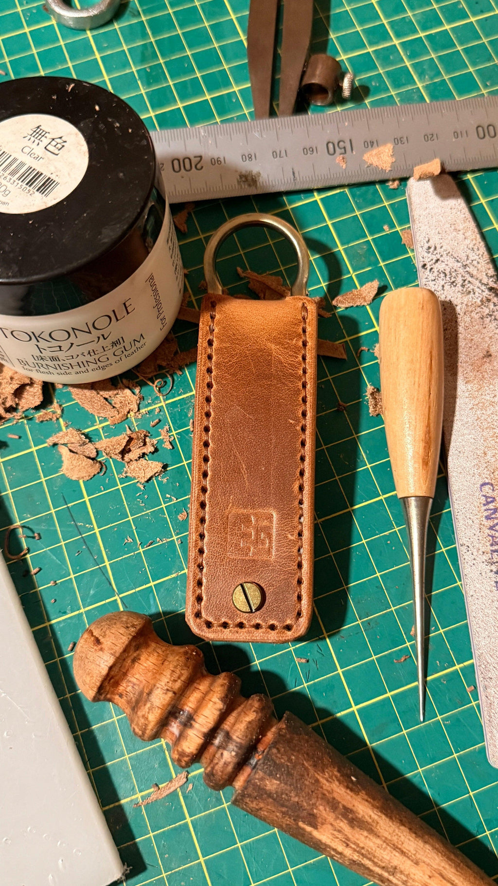 Key Fob with Crafting tools and materials on a green cutting mat