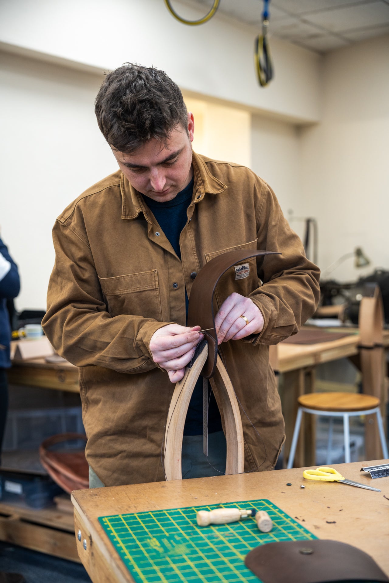 Man working on a leather project in a workshop